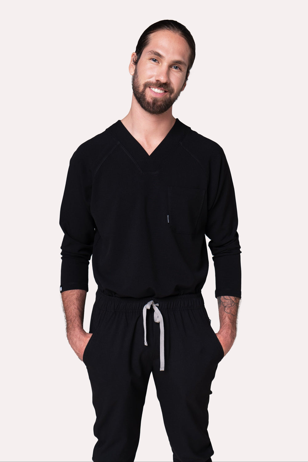 Model wearing Classic Black Scrub Top with black scrub pants