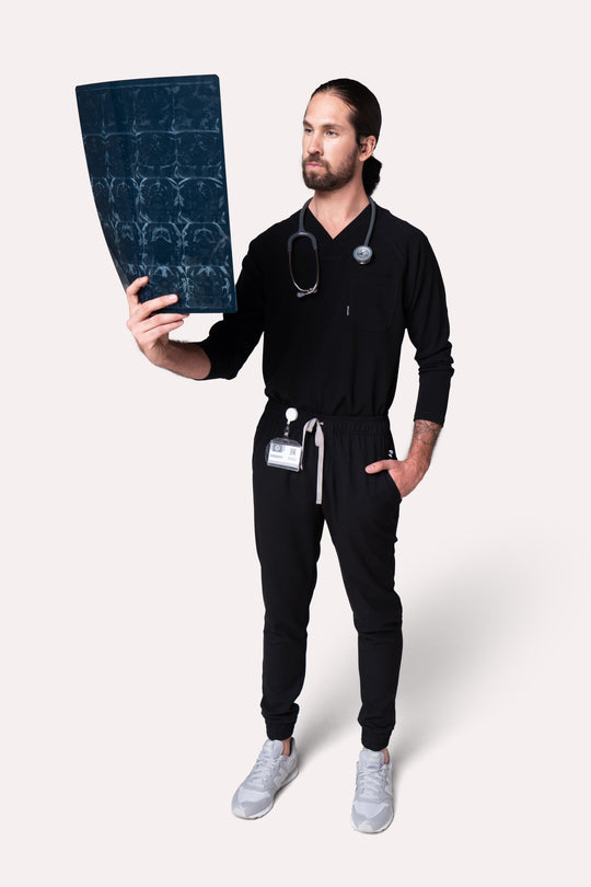 Healthcare professional wearing Classic Black Scrub Top during a work shift