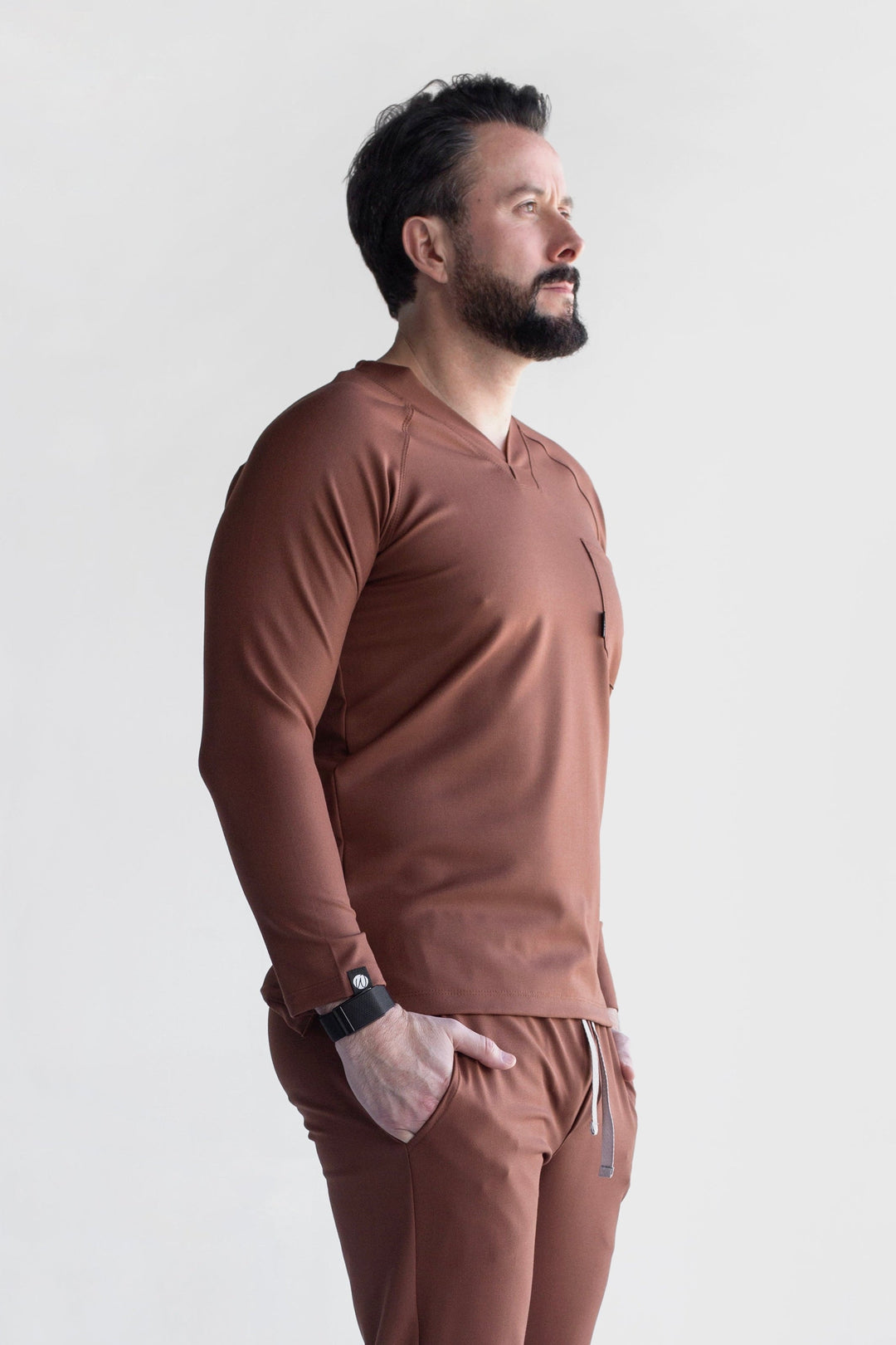 Side view of Classic Cocoa Scrub Top showing the long sleeves and straight professional fit