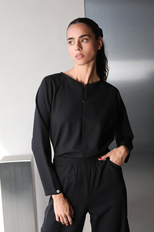 Woman wearing Fall Black Scrub Top by Work &amp; Chill