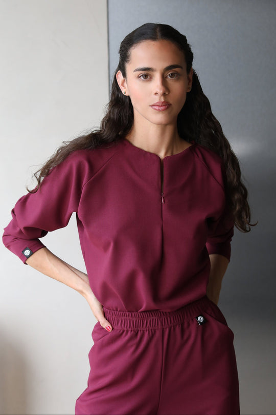 Woman wearing Fall Burgundy Scrub Top by Work &amp; Chill
