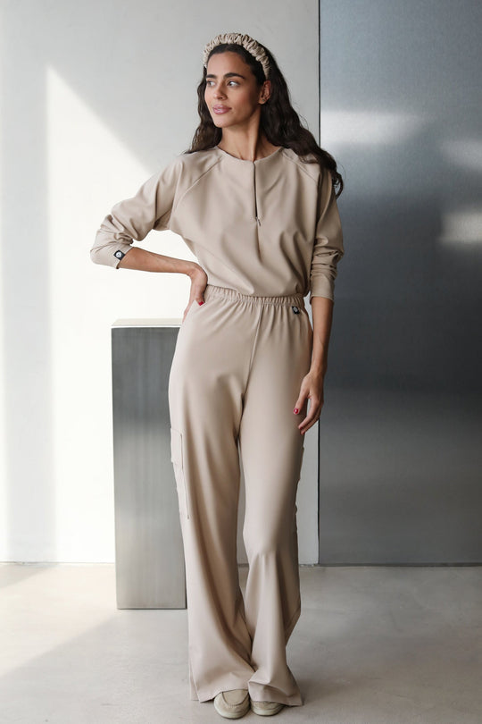 Model wearing Fall Natural Scrub Top with matching scrub pants