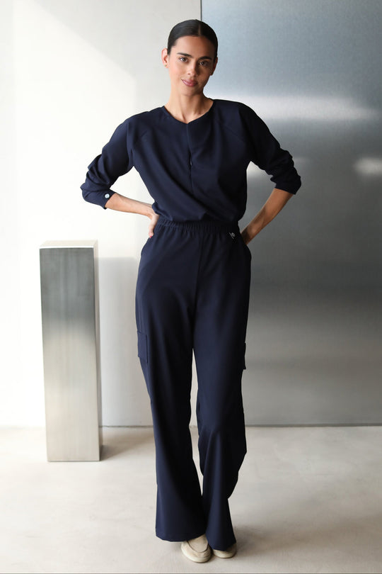 Side view of Fall Navy Scrub Top showing the long-sleeve fit