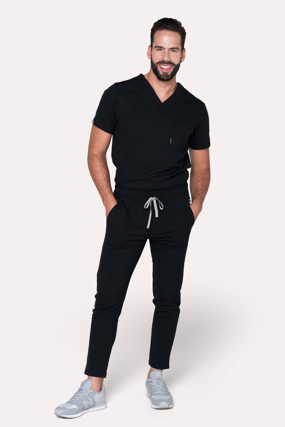 Man wearing Fresh Black Scrub Pants showing the tapered jogger silhouette