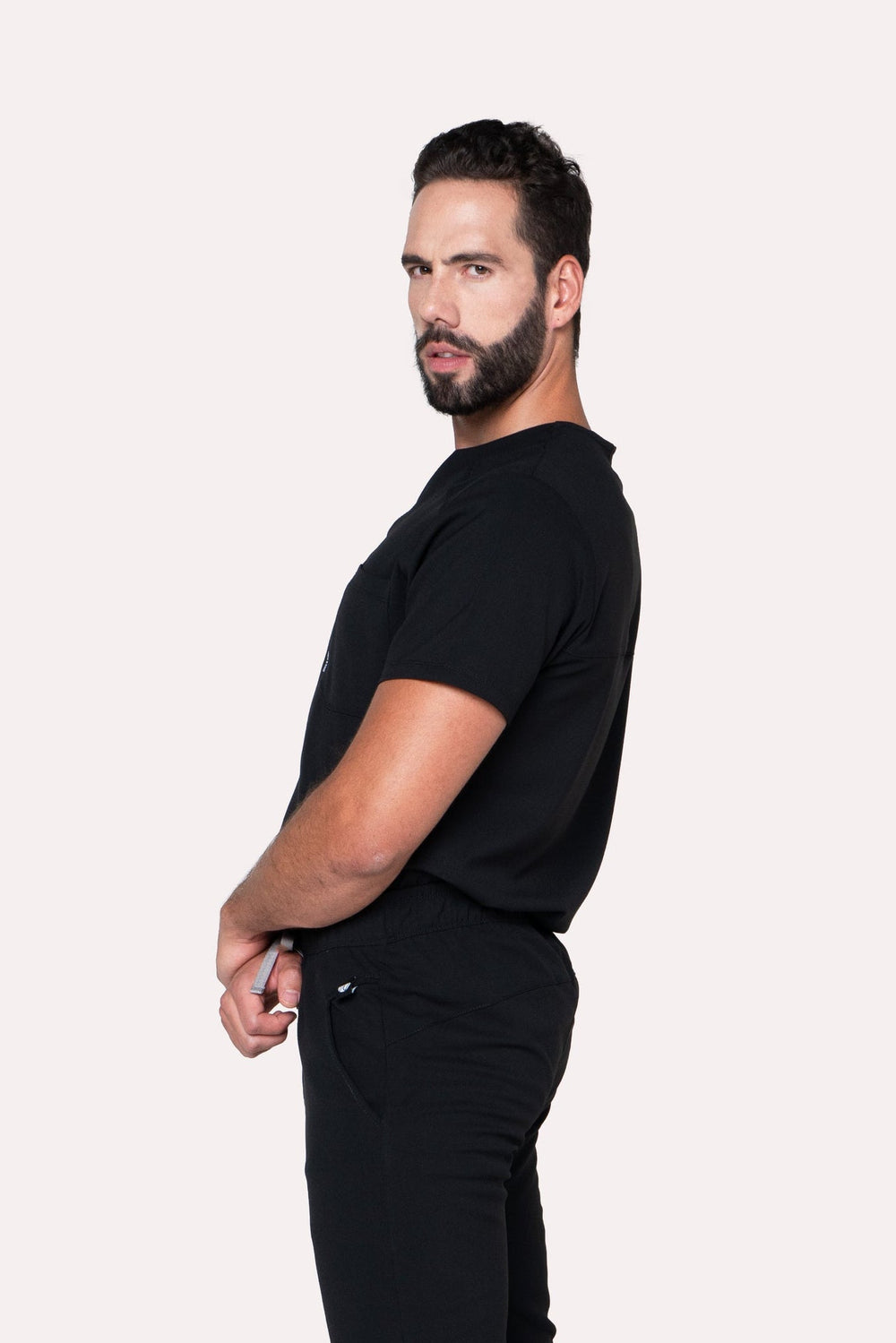 Side view of Fresh Black Scrub Top showing the relaxed fit