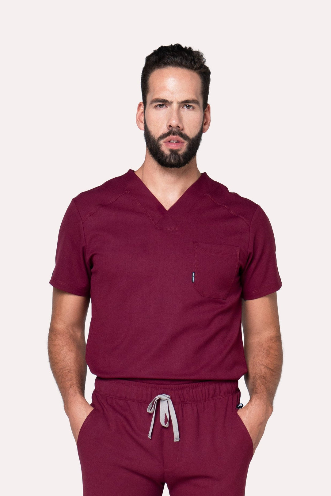 Model wearing Fresh Burgundy Scrub Top with matching Fresh Scrub Pants