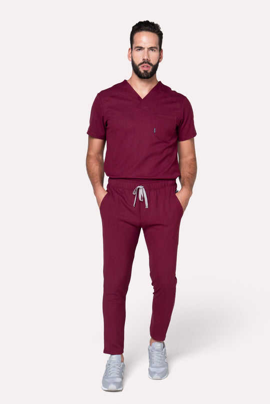 Man wearing Fresh Burgundy Scrub Pants showing the tapered jogger silhouette