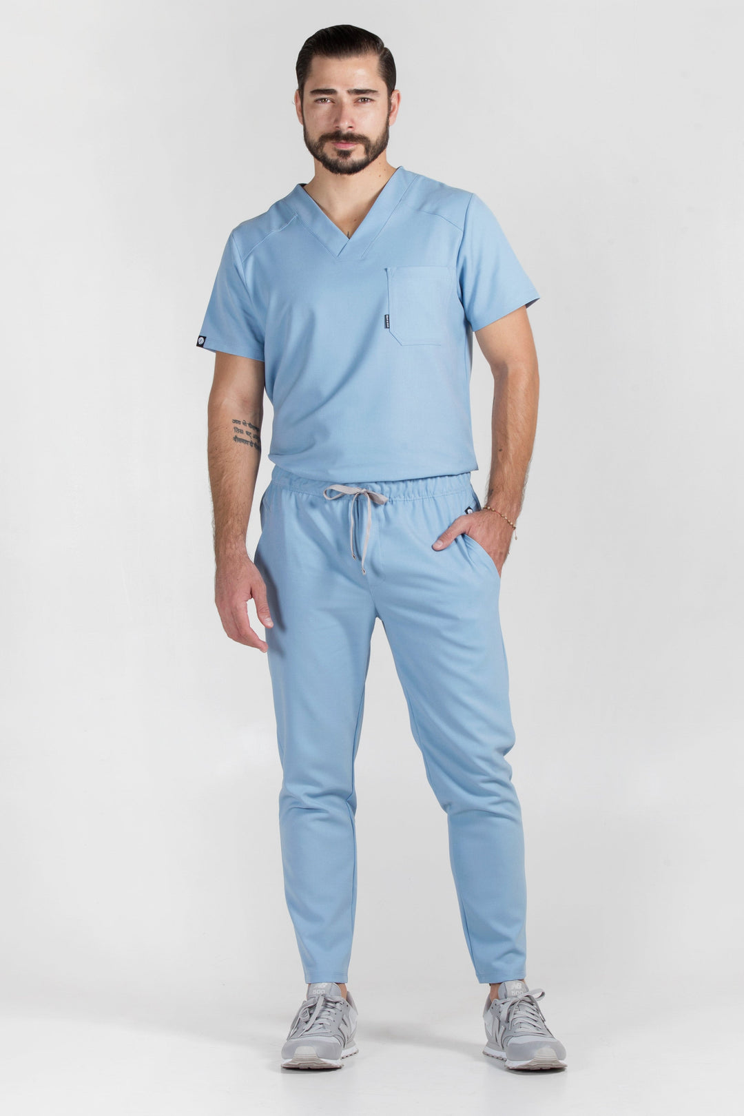 Man wearing Fresh Dream Blue Scrub Pants showing the tapered jogger silhouette