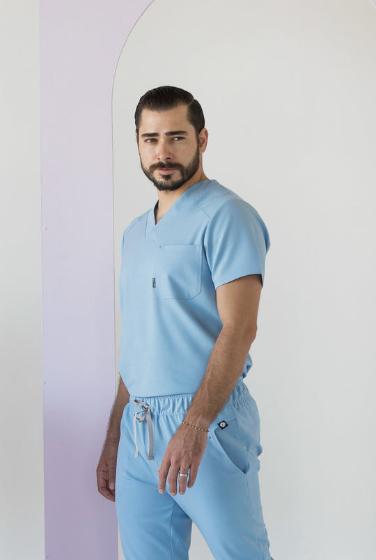 Side view of Fresh Dream Blue Scrub Top showing the relaxed fit and V-neckline