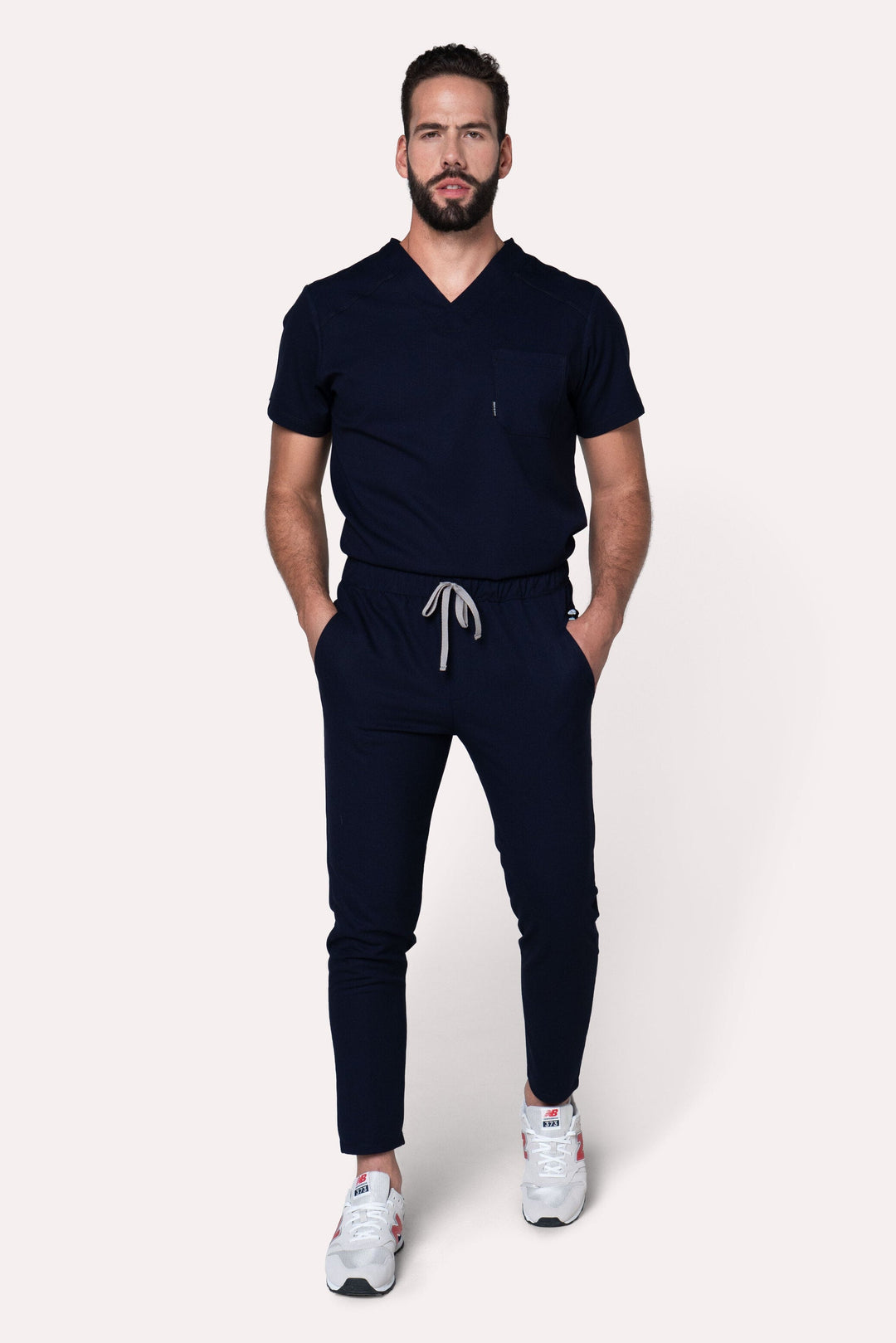 Man wearing Fresh Navy Scrub Pants showing the tapered jogger silhouette