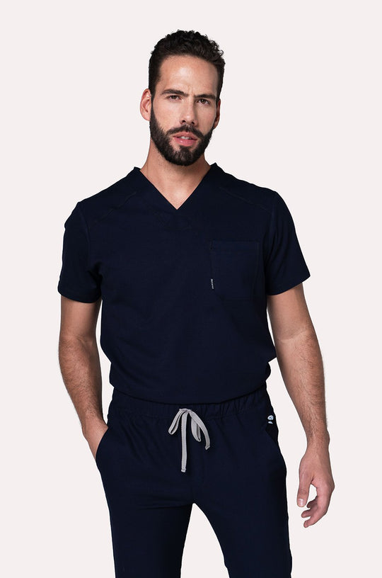 Model wearing Fresh Navy Scrub Top with matching Fresh Scrub Pants