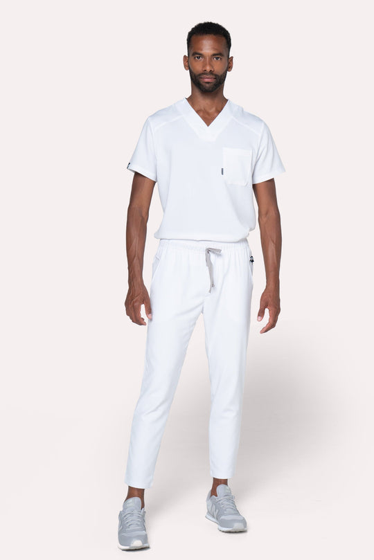 Man wearing Fresh White Scrub Pants showing the tapered jogger silhouette
