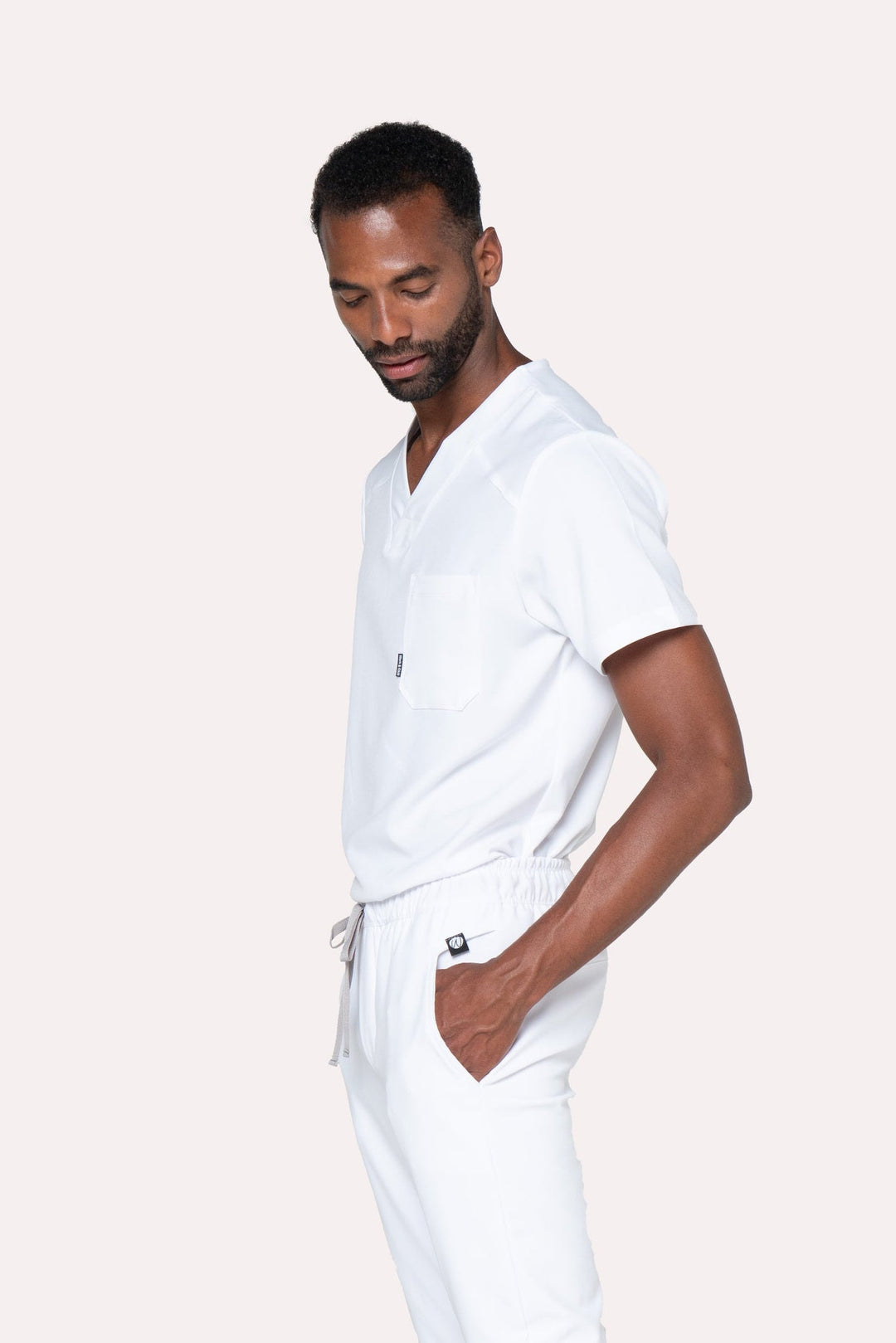 Three-quarter view of Fresh White Scrub Top showing the relaxed fit and V-neckline
