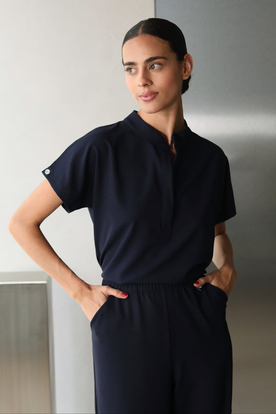 Woman wearing Glam Navy Scrub Top by Work &amp; Chill