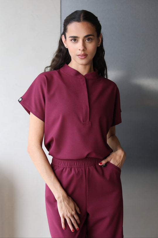 Woman wearing Glam Burgundy Scrub Top by Work &amp; Chill