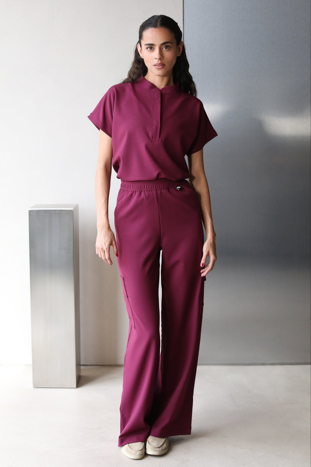 Front view of Glam Burgundy Scrub Top styled with matching scrub pants