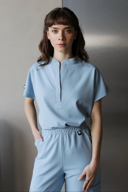 Woman wearing Glam Dream Blue Scrub Top by Work &amp; Chill