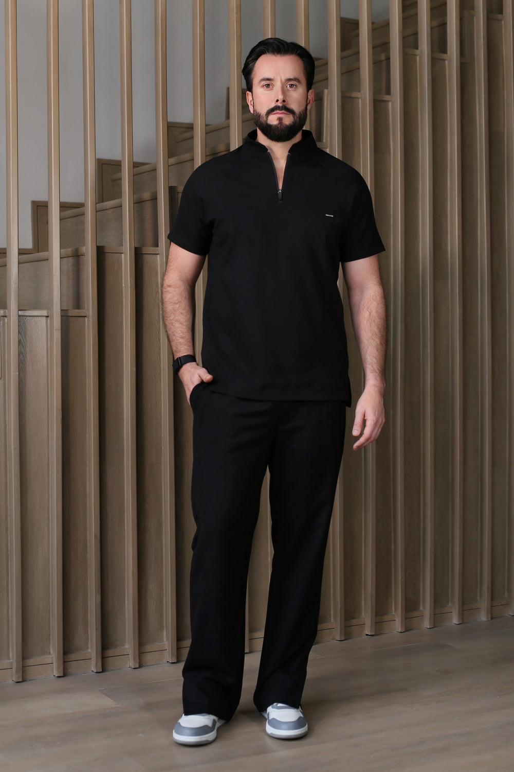Model wearing Harry Black Scrub Pants with matching Harry Scrub Top
