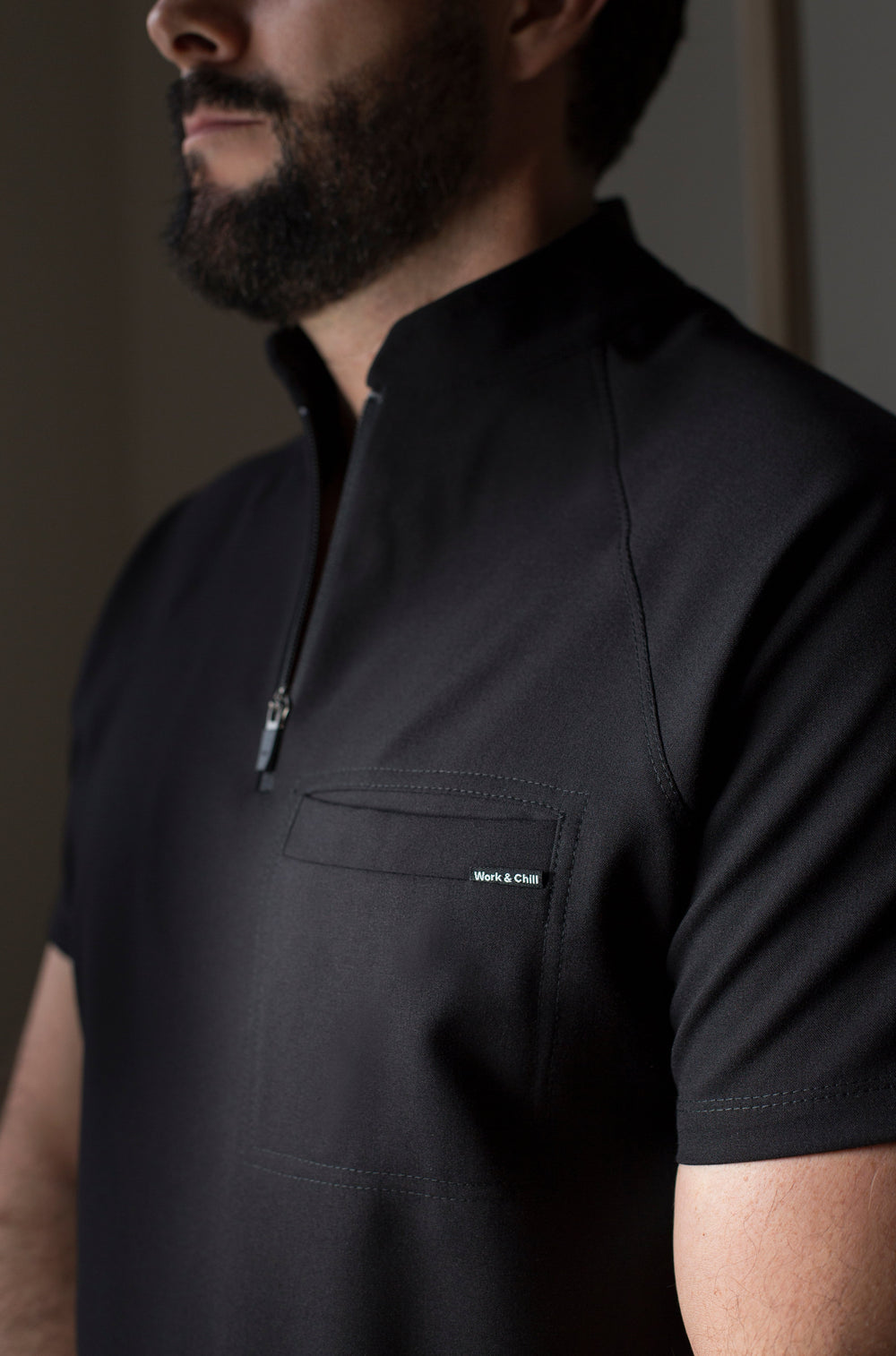 Close-up of Harry Black Scrub Top showing the high collar and zipper neckline