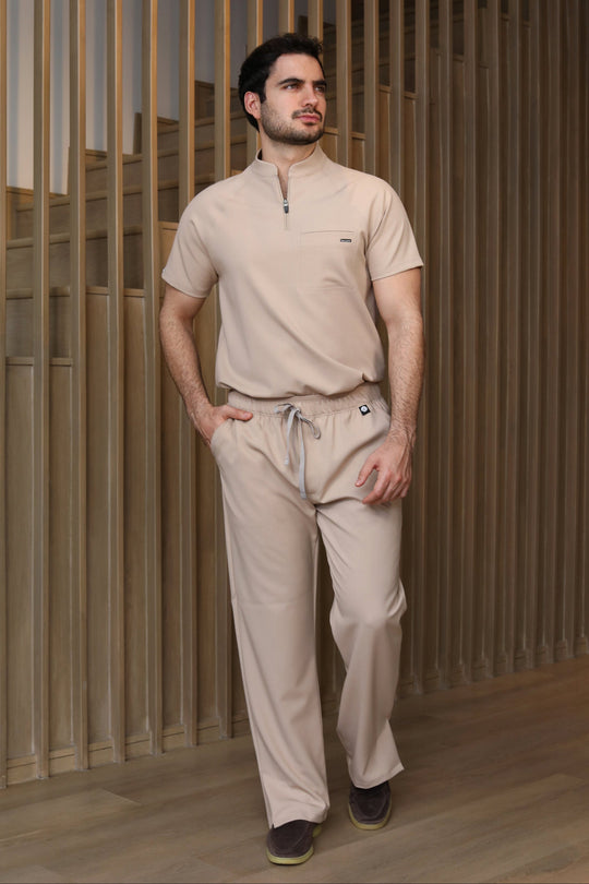 Male model wearing Harry Natural Scrub Pants in a full-body walking pose.