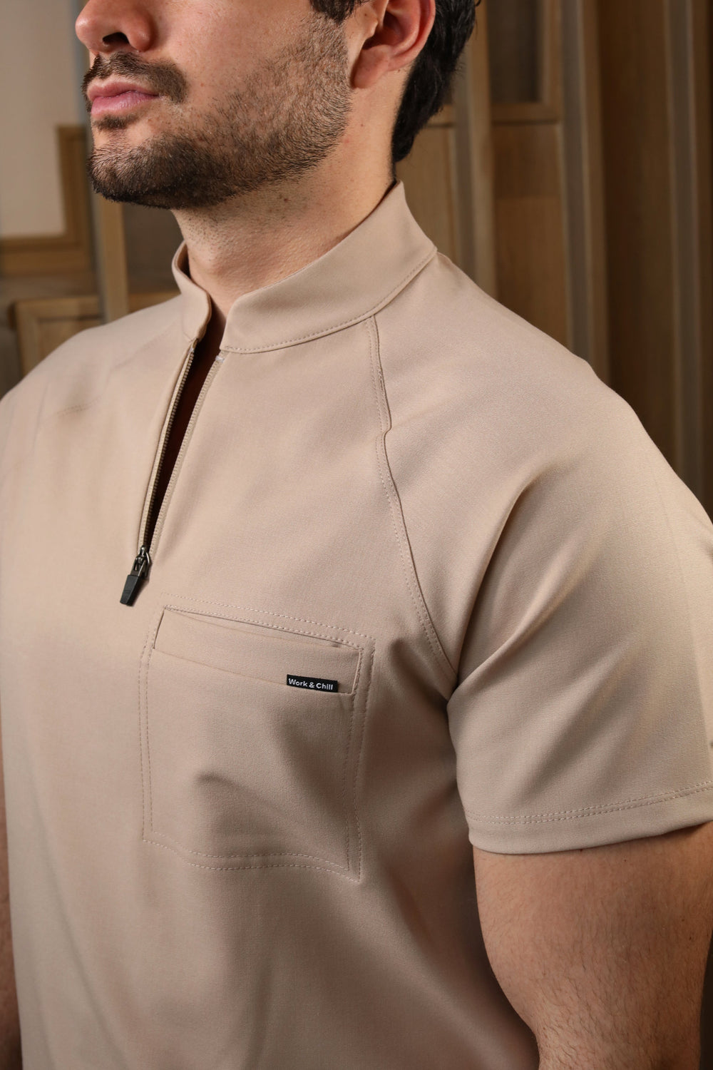Close-up of Harry Natural Scrub Top showing the high collar and zipper neckline