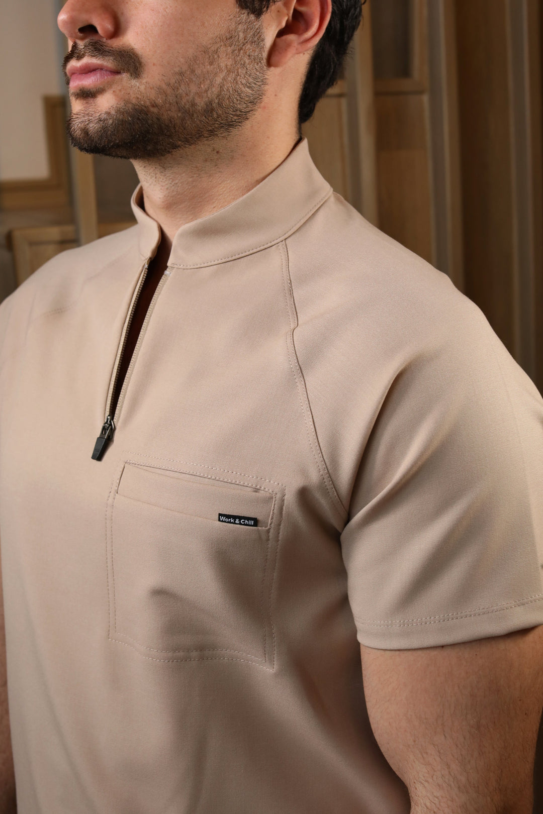Close-up of Harry Natural Scrub Top showing the high collar and zipper neckline