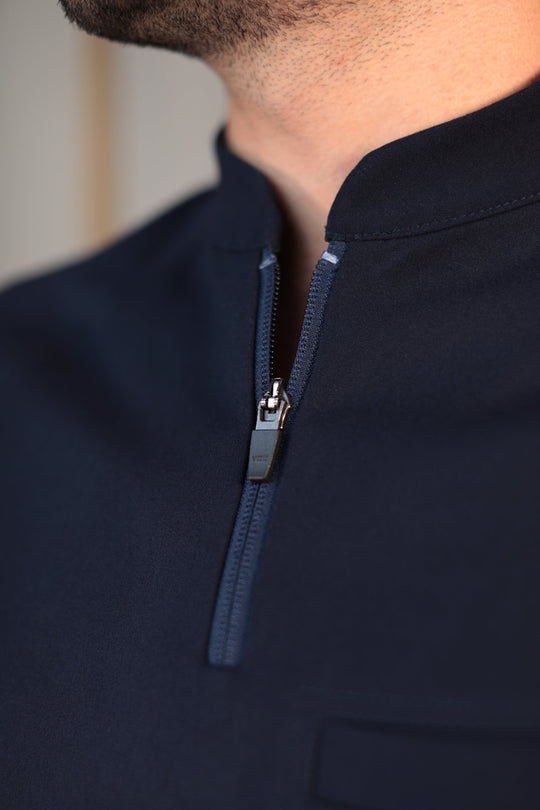 Close-up of Harry Navy Scrub Top showing the high collar and zipper neckline