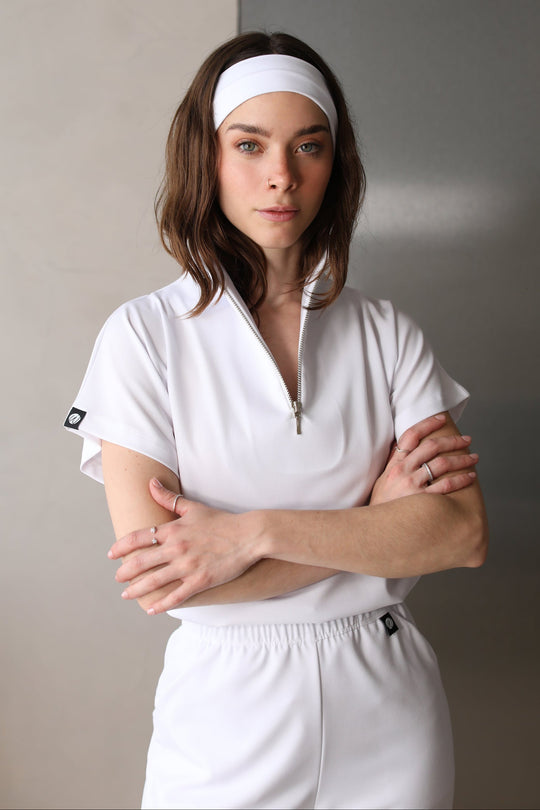 Front view of Victory Crystal White Scrub Top showing the relaxed fit