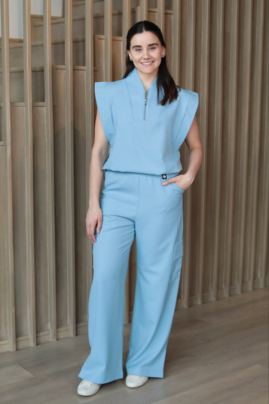 Model wearing Kate Dream Blue Scrub Pants with the matching Kate Scrub Top