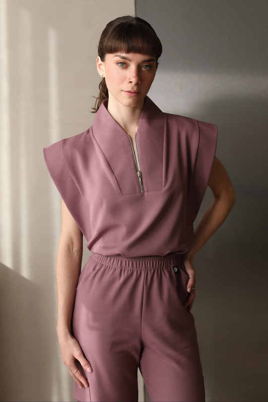 Woman wearing Kate Mauve Scrub Top by Work &amp; Chill