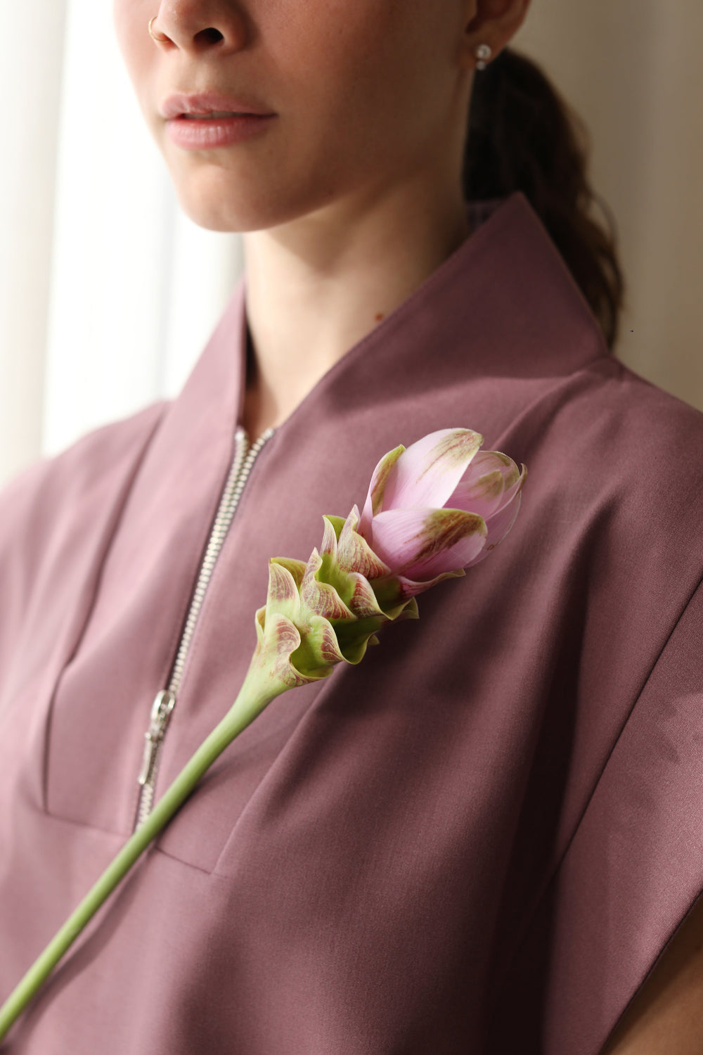 Front detail of Kate Mauve Scrub Top with zipper neckline