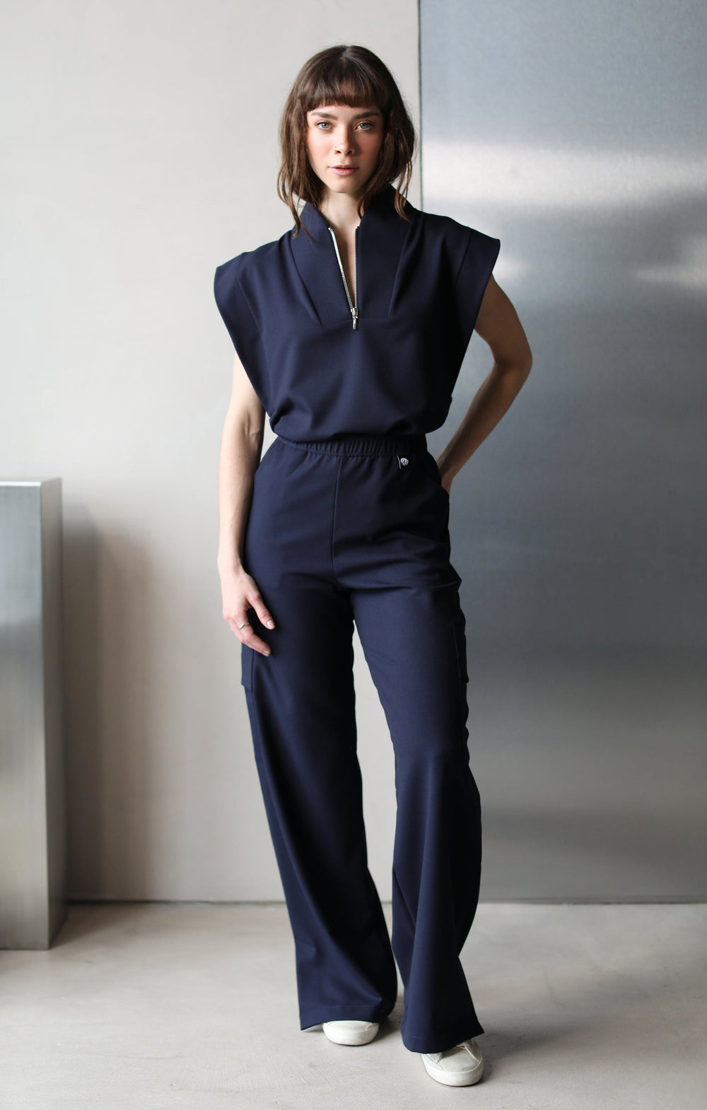 Model wearing Kate Navy Scrub Pants with matching scrub top