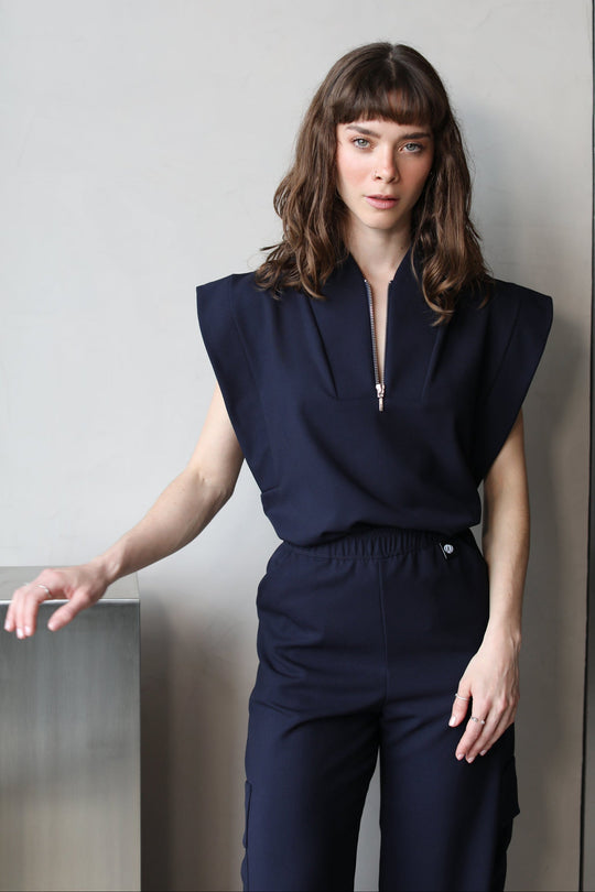Woman wearing Kate Navy Scrub Top by Work &amp; Chill