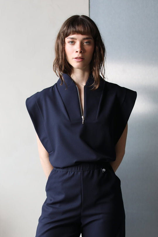 Model wearing Kate Navy Scrub Top with matching scrub pants