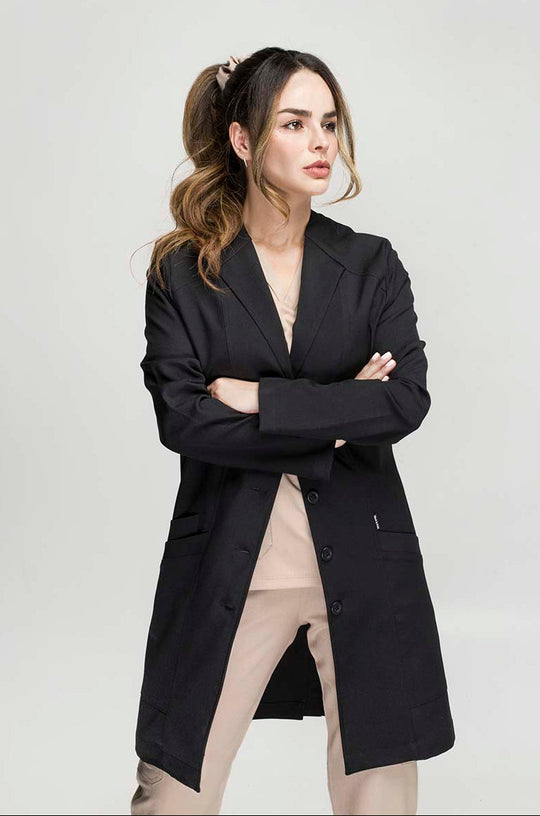 Healthcare professional wearing Women’s Black Medic Coat showing the classic medical silhouette