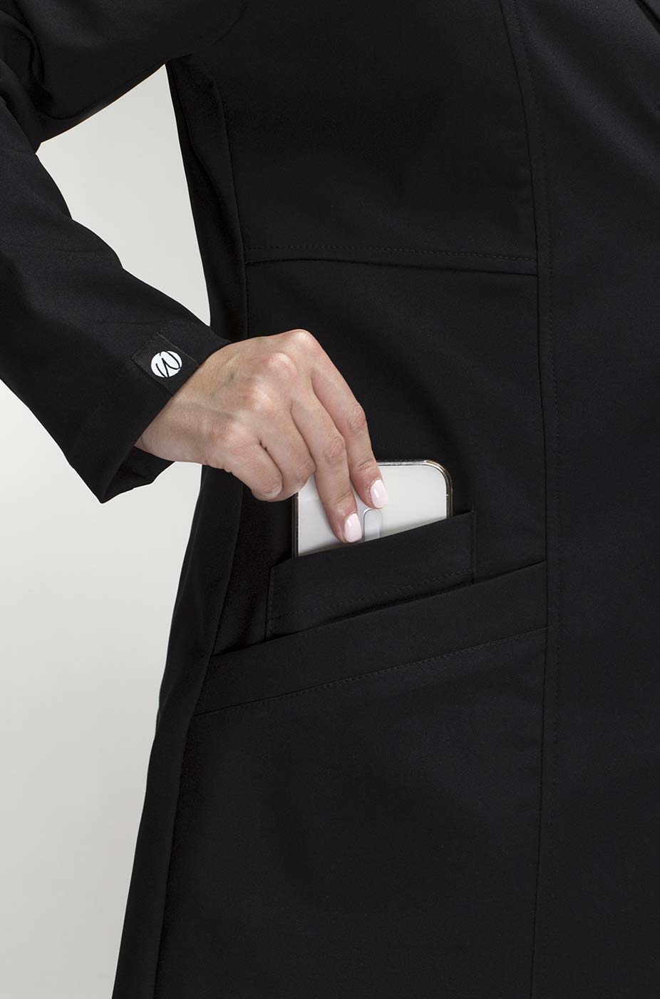 Close-up of Women’s Black Medic Coat showing the functional front pocket