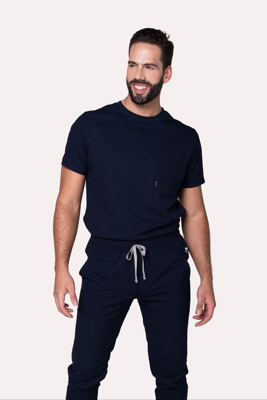 Model wearing Sport Navy Scrub Top with matching navy scrub pants