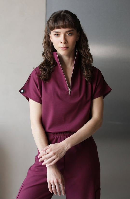 Woman wearing Victory Burgundy Scrub Top by Work &amp; Chill