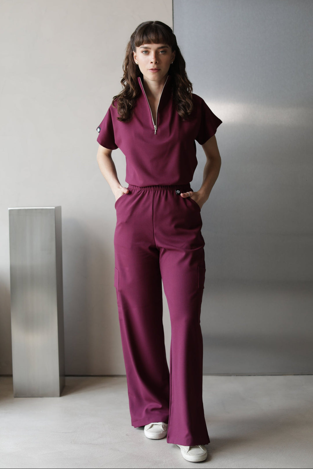 Model wearing Victory Burgundy Scrub Top with matching scrub pants