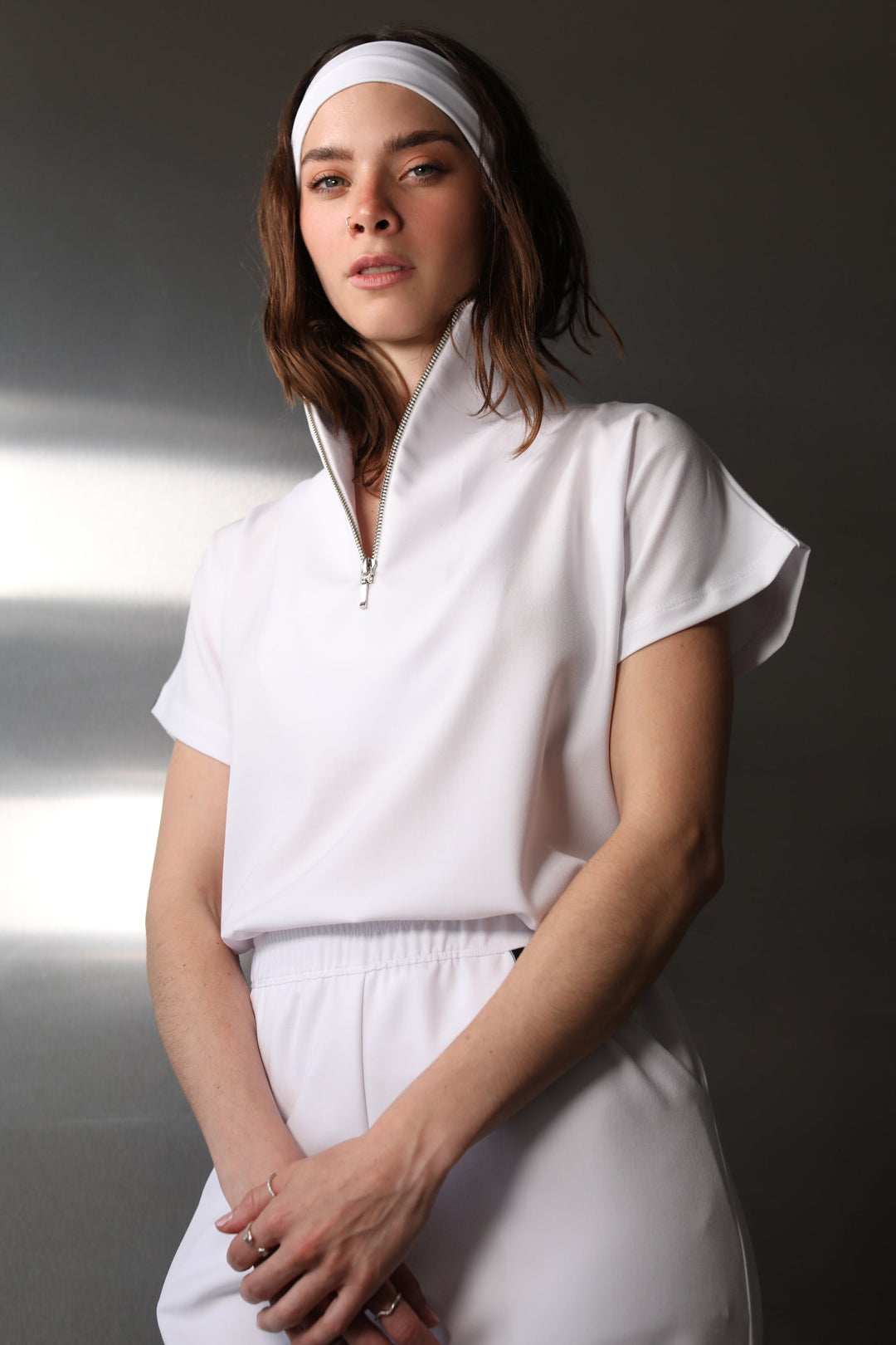 Woman wearing Victory Crystal White Scrub Top by Work & Chill