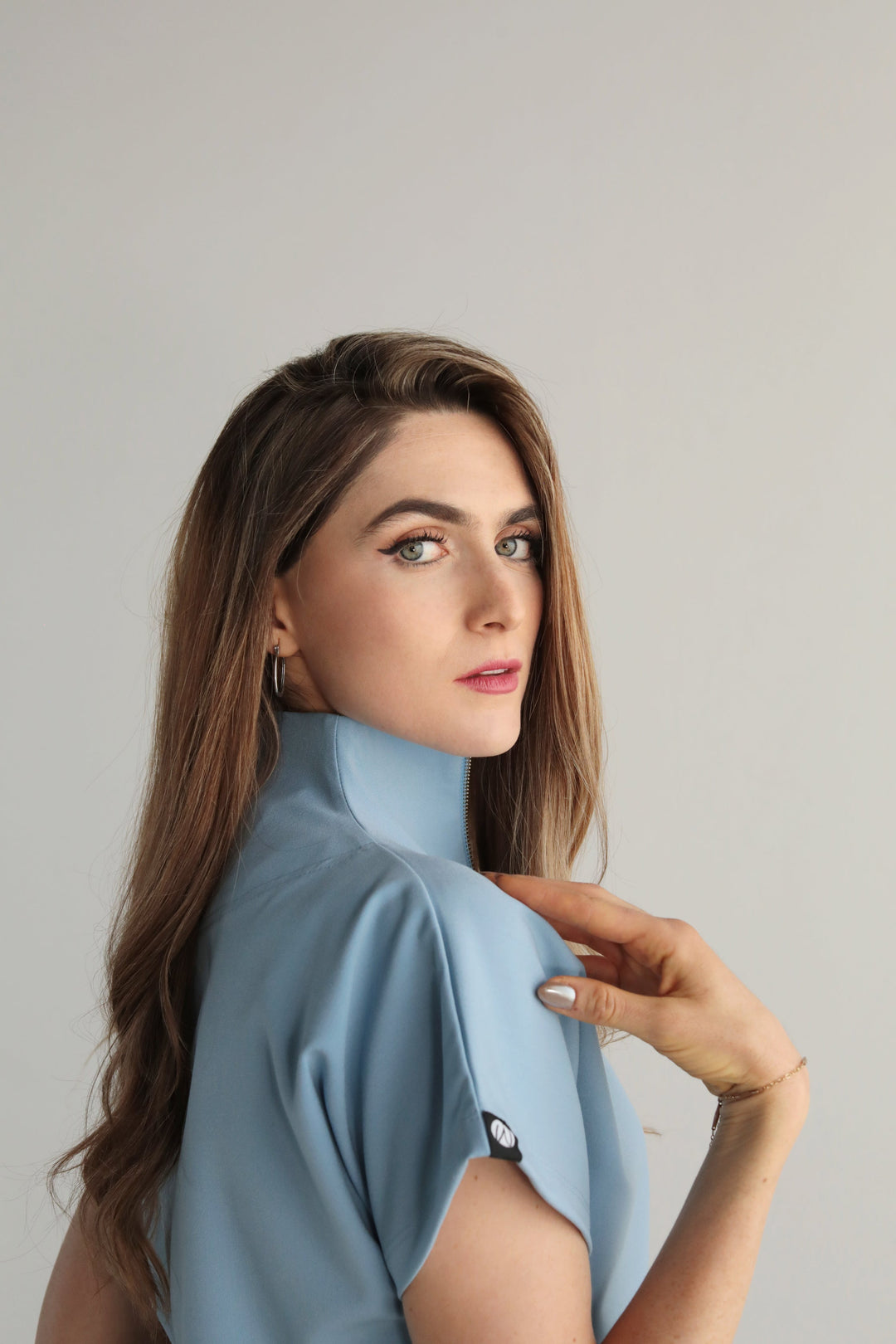 Side detail of Victory Dream Blue Scrub Top showing the sleeve and relaxed silhouette