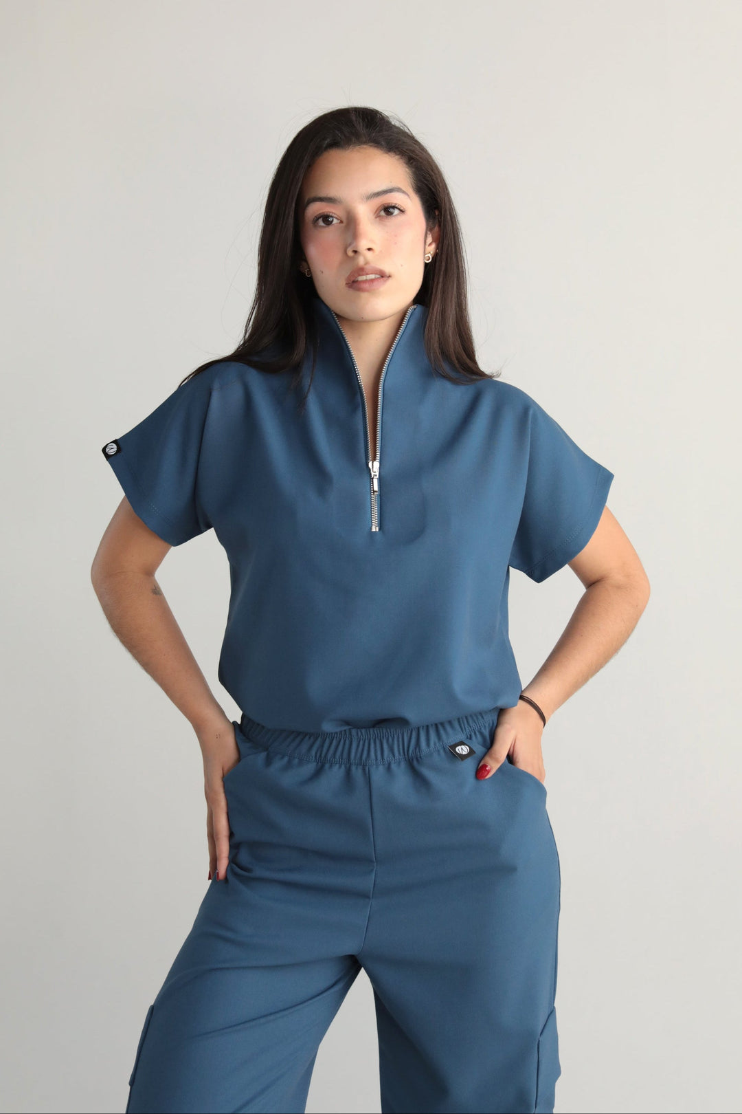 Woman wearing Victory Indigo Scrub Top by Work & Chill