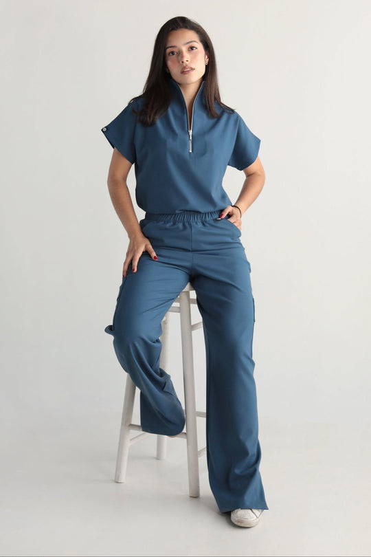 Model wearing Victory Indigo Scrub Top with matching scrub pants