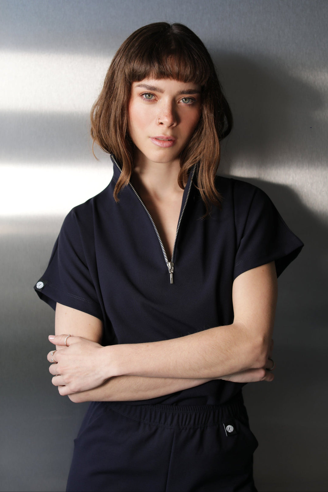 Front detail of Victory Navy Scrub Top showing the zipper neckline